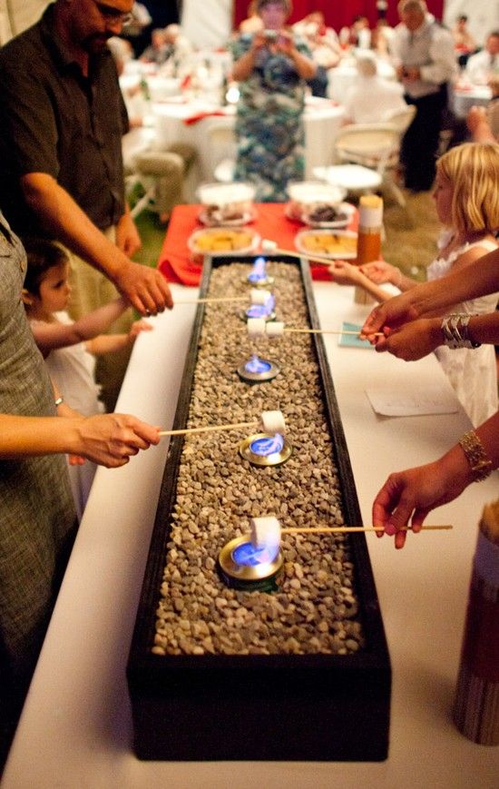 S'more bar for your wedding. Here is a list of creative wedding bar ideas you can use to set up your wedding. Wedding decoration ideas that will wow your wedding guests. Here is a list of the best food reception stations you can set up to entertain your wedding guests. Unique Wedding station ideas for your reception. #Weddingstation #weddingbarideas #weddingideas