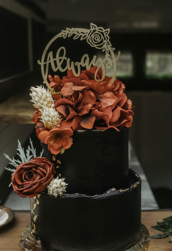Harry Potter Inspired Wedding Cake. Jewel tones and moody décor add a sophisticated touch to this fun theme. Paired with metallic details and a modern black wedding cake, this design is stunningly whimsical. From golden snitch centerpieces to floating candles, you’ll recognize plenty of references to the famous book series! 