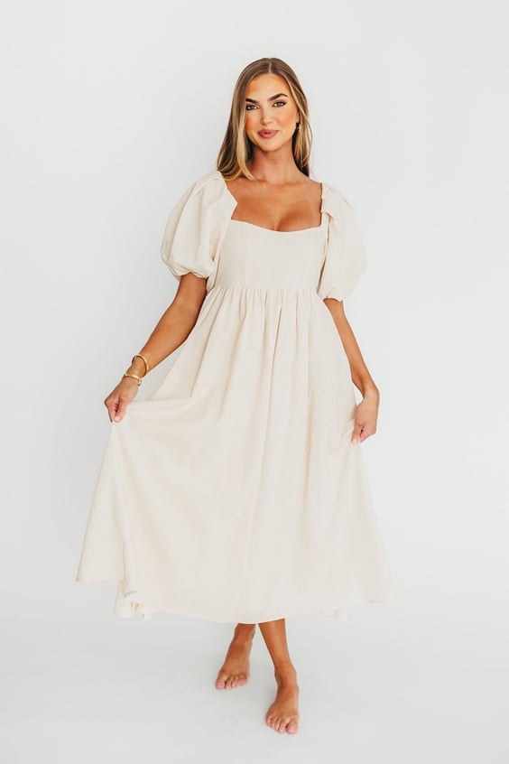 If you are looking for a gorgeous long flowy dress for an engagement shoot, check out this stunning white Maxi Dress! It's the perfect engagement photo outfit!