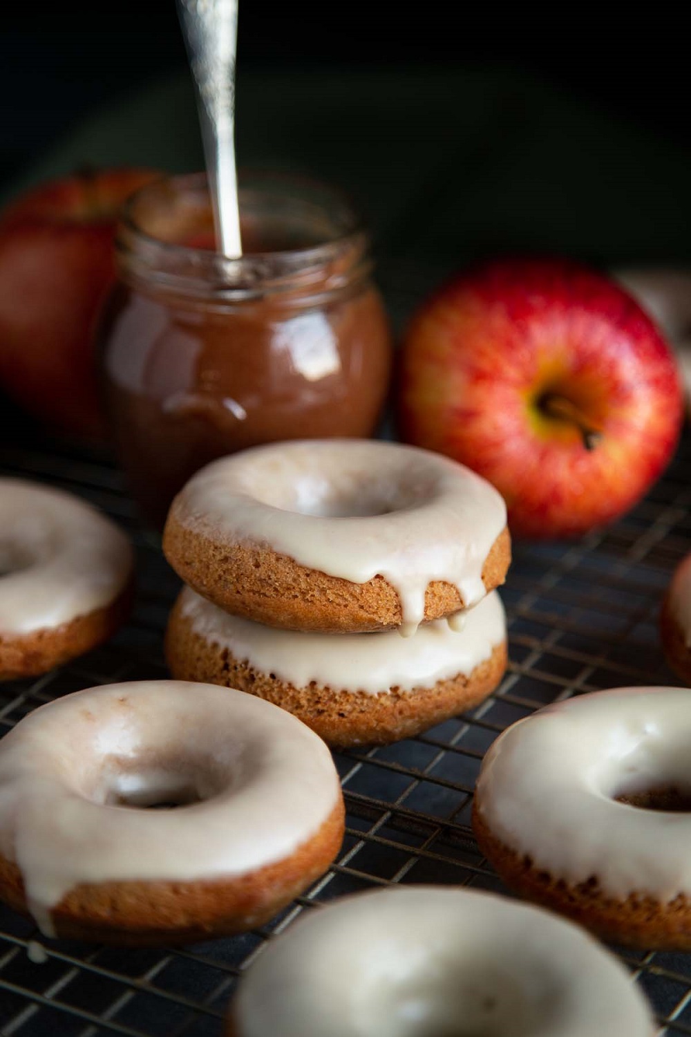 Delicious Baked Apple Butter Donuts with Maple Glaze! These lightly spiced and ultra moist Baked Apple Donuts are made with homemade apple butter and dipped in a sweet maple glaze for all the good Fall vibes. They are extremely easy to make and you don’t even need to bust out your frying pan!
