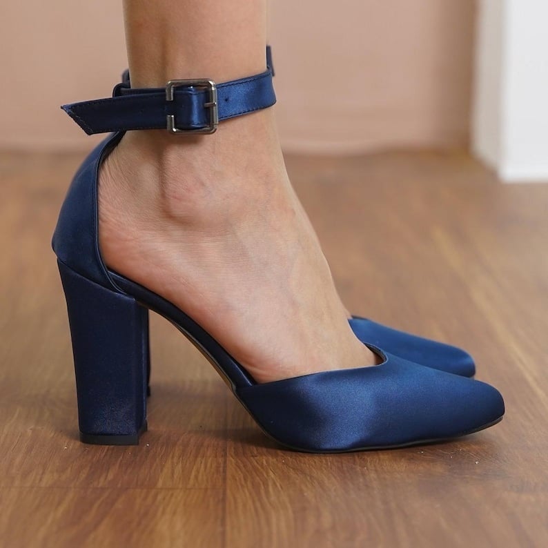 If you're looking for a comfortable yet chic shoe option for your wedding day, look no further than these Navy Satin Pointy Toe Pump Low Heels. The luxurious navy satin material and the elegant pointy-toe design make these shoes perfect for adding a touch of sophistication to any bridal look. The low heel ensures that you can dance the night away without sacrificing comfort. These pumps are versatile enough to wear again and again beyond your big day, making them a smart investment for any bride-to-be.