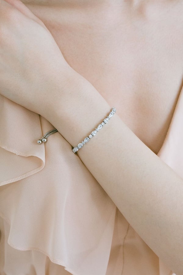 Jewelry ideas for Bridesmaids - Capture the sparkle of your wedding day with a stunning crystal bridesmaid bracelet, a perfect blend of elegance and sentimentality. Each bracelet, adorned with shimmering crystals, adds a touch of sophistication to your bridesmaids' ensembles, enhancing their look with a radiant glow. This timeless accessory not only complements their attire but also serves as a cherished keepsake, symbolizing your gratitude and the beautiful bond you share. Thoughtfully designed to suit various styles, these bracelets are an exquisite gift that your bridesmaids will treasure long after the celebrations end, wearing them on other special occasions as a reminder of your unforgettable day.