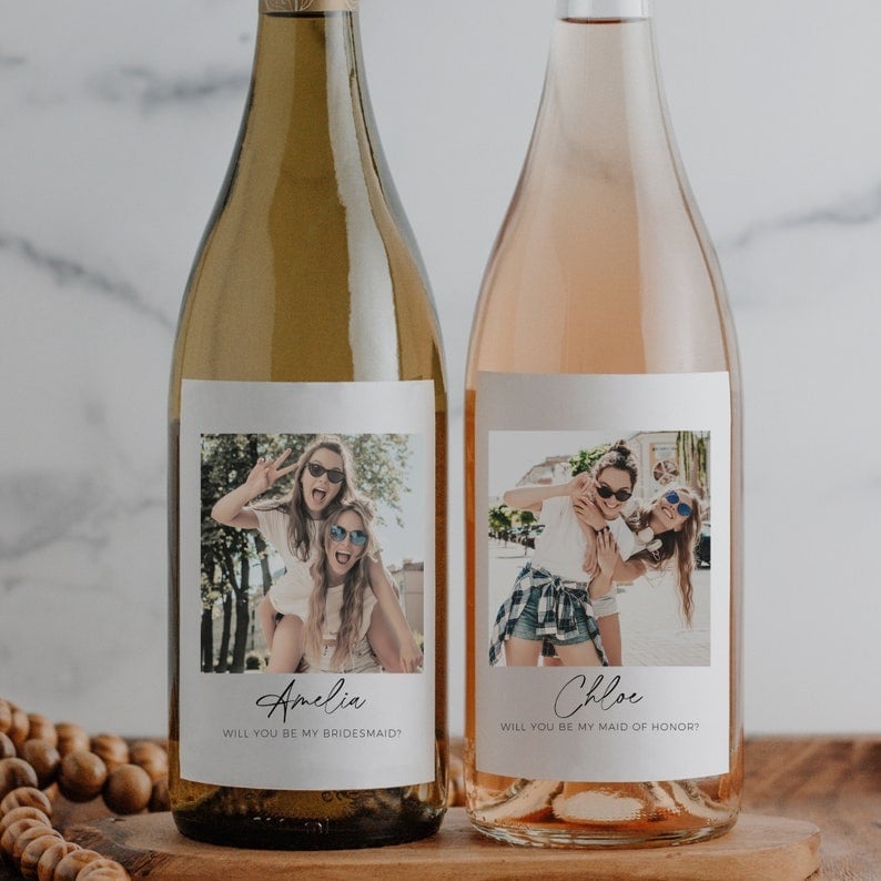 Looking for a unique and memorable way to pop the question to your bridesmaids? Consider a personalized wine bottle label! This elegant and creative approach allows you to customize a bottle of their favourite wine with a heartfelt message. The label can include their name, your wedding date, and a charming design that matches your wedding theme. It's a keepsake they'll cherish long after the wine is gone. Perfect for a wine-loving friend, this thoughtful gesture is sure to bring a smile to their face and make them feel truly special. Cheers to friendship and unforgettable memories! 🍷💍