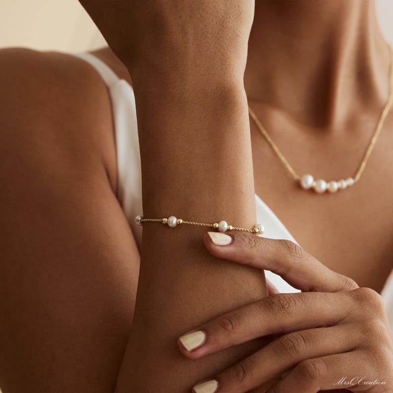 Jewelry ideas for Bridesmaids - Searching for the perfect bridesmaid gift that combines elegance, sentiment, and timeless style? Look no further than these exquisite Pearl Bead Bracelets. These beautiful pieces offer a touch of sophistication and grace, ideal for complementing any wedding theme or bridesmaid dress. Each bracelet features lustrous pearls that elegantly catch the light, adding a classic touch to your wedding day. Not only are they a stunning accessory for your bridesmaids to wear during the ceremony, but they also serve as a meaningful keepsake to cherish for years to come. Show your appreciation with this elegant gift that celebrates your special bond and complements your bridal ensemble. With their versatility and enduring charm, these pearl bracelets are a thoughtful choice that your bridesmaids and maid of honor will adore. Give the gift of timeless elegance with these pearl treasures that will forever remind them of your beautiful day.