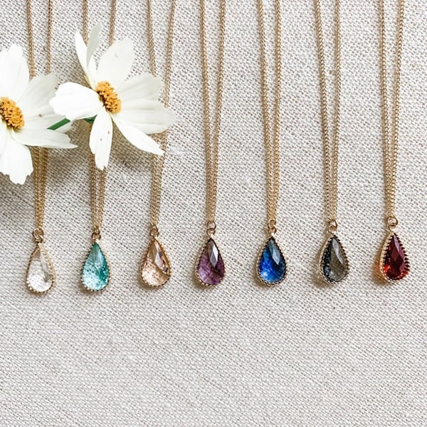 Teardrop Bridesmaid Necklace: A Timeless Gift! Elevate your bridal party's elegance with the exquisite Colourful Teardrop Bridesmaid Necklace. This stunning piece makes for a perfect wedding day gift, celebrating the unique style of each bridesmaid and your maid of honour. With its vibrant teardrop design, this necklace adds a splash of color that complements any wedding theme, from rustic chic to classic elegance. Crafted to be both eye-catching and versatile, it serves as a beautiful keepsake of your special day. Each necklace is a token of appreciation, symbolizing the bond you share. Its timeless design ensures it will be cherished and worn long after the wedding, making it a thoughtful and lasting gift. Choose this necklace to convey your gratitude and enhance your bridal party's ensemble.