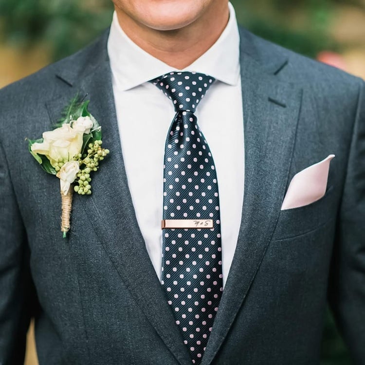 Looking for a unique and personal touch for the groom's wedding attire? Discover our Engraved Tie Clip – the perfect blend of style and sentiment. This sleek accessory can be customized with initials, a special date, or a meaningful message, making it a cherished keepsake. Perfect for adding a touch of elegance to his suit, this tie clip is ideal for the wedding day and beyond. Whether he prefers a classic or contemporary look, this personalized gift is sure to impress and become a treasured memento of your special day together.
