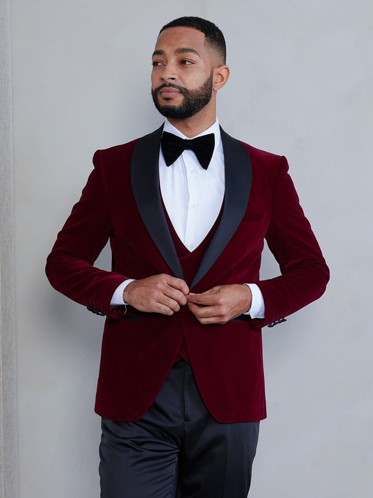 Merlot Groom Suit: Bold Elegance! Elevate your wedding style with a stunning merlot groom suit that exudes bold elegance and sophistication. Perfect for a fall or winter wedding, this rich, deep hue adds a touch of romance and warmth to your special day. Pair it with a crisp white shirt and a sleek black tie for a classic look, or mix it up with a patterned bow tie for a modern twist. Ideal for grooms who want to make a stylish statement, this merlot suit is both unique and timeless, ensuring you stand out as you say "I do."