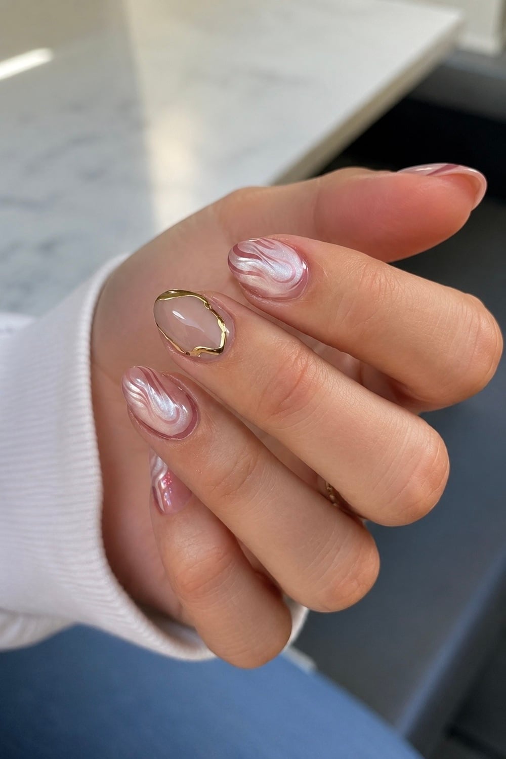 Elevate your manicure game with stunning Rose Quartz Nail Art, a design that embodies elegance and tranquillity. Perfect for those seeking a touch of natural beauty, these ethereal nails blend soft pink hues with delicate marbling, reminiscent of the healing gemstone. Ideal for occasions like weddings or everyday glamour, this look resonates with the trend of crystal-inspired nail art. Incorporate gemstone nails, pastel nail designs, and minimalist nail trends into your style. Discover the magic of rose quartz and let your nails shine with serene sophistication!
