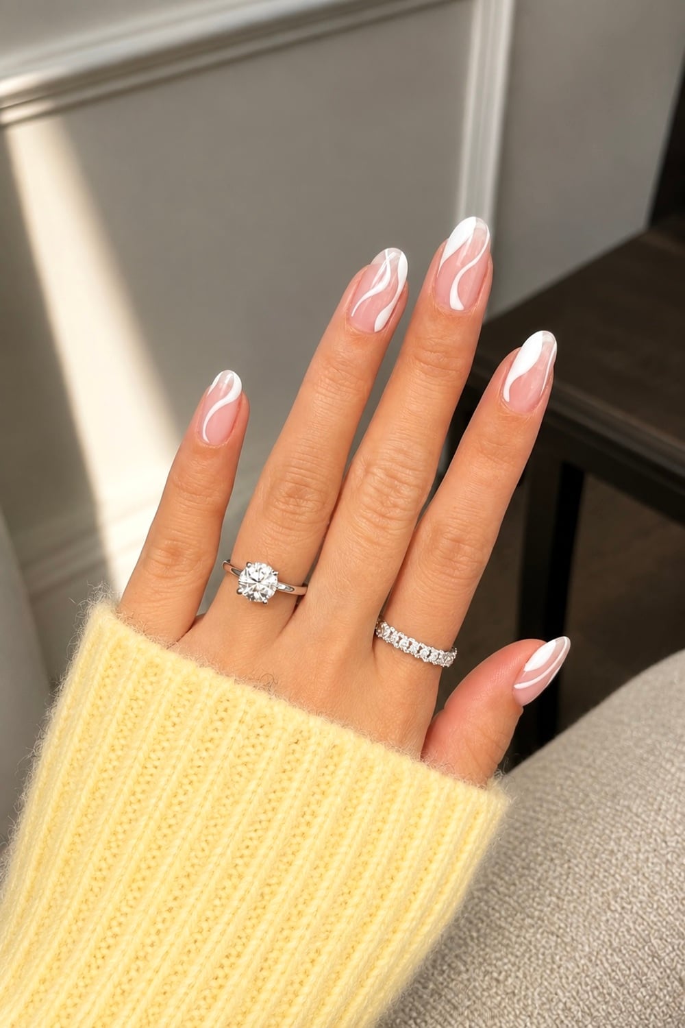 Elevate your nail game with white swirl nails, a timeless and elegant choice for any occasion. These swirl nail designs offer a sophisticated twist, blending minimalism with artistic flair. Perfect for weddings, parties, or everyday elegance, this style is versatile and chic. Add a touch of sparkle with glitter accents or keep it classic with a glossy finish. Discover the beauty of minimalist nail art and let your hands make a statement. This is an elegant nail for brides-to-be and is an extremely popular chic nail trend.