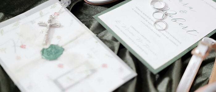 Bride checking off her week of wedding checklist while organizing wedding dress, rings, bouquet, shoes, and wedding day essentials.